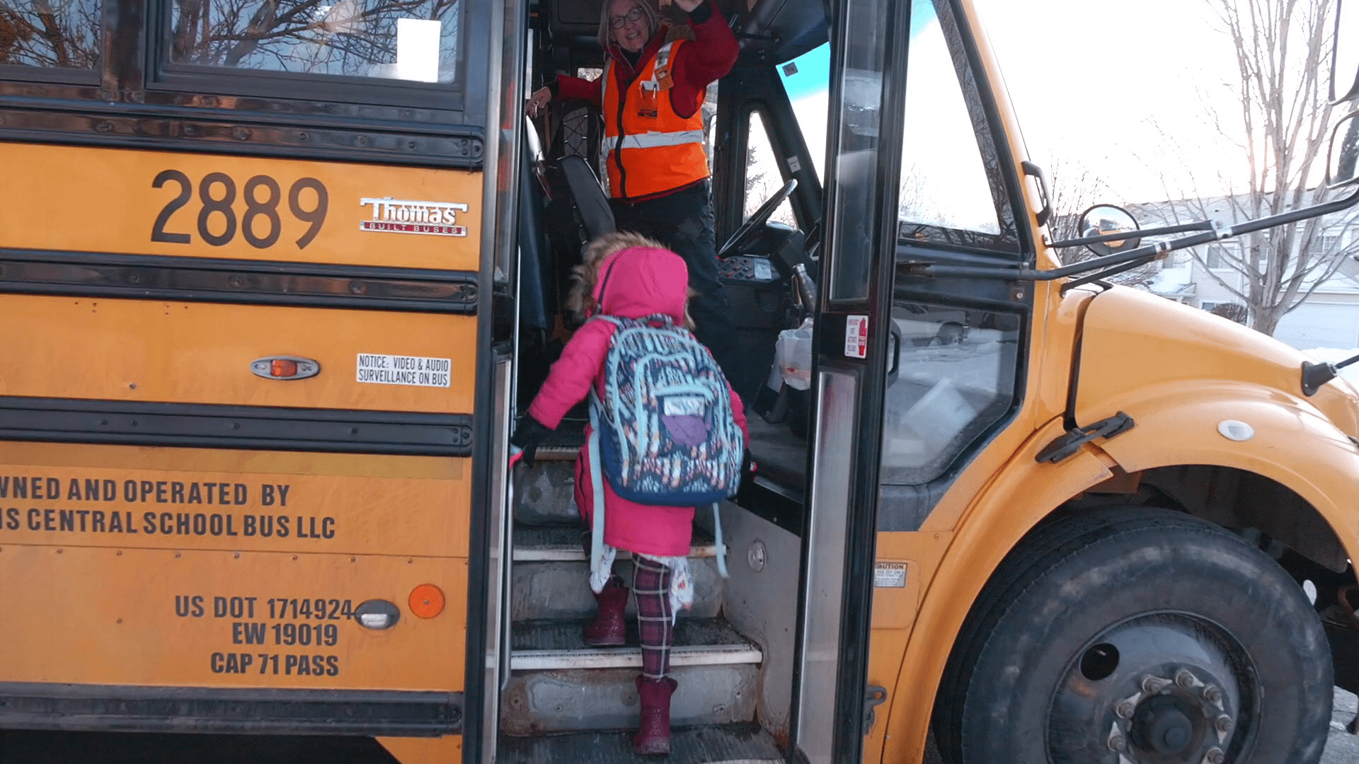 Screenshot: Bus driver greeting student as they enter the school bus