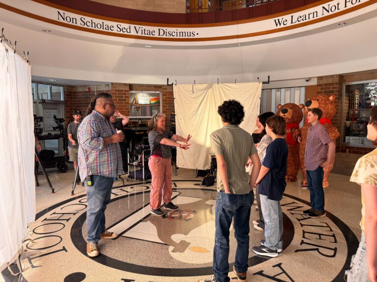 group filming in a large lobby